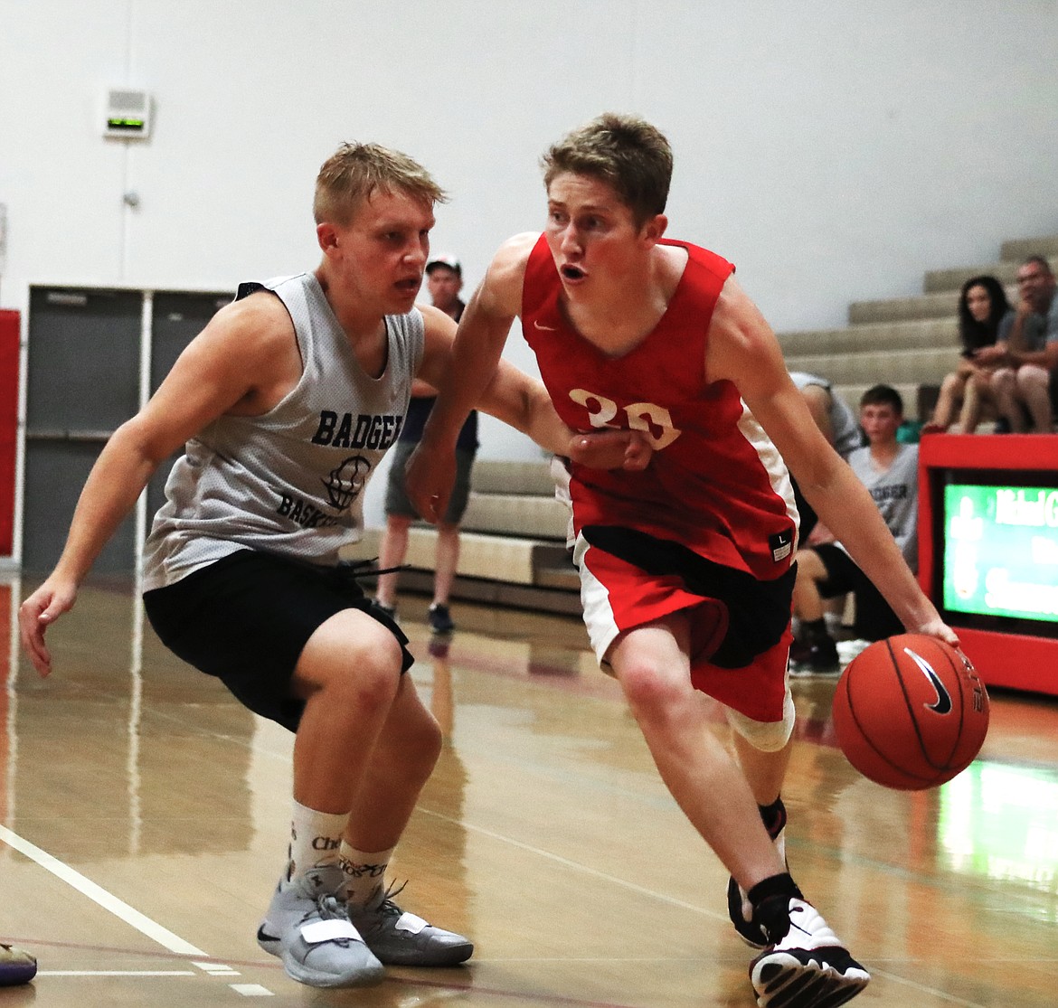 (Photo by KYLE CAJERO)
Sandpoint senior Kobe Banks drives past Bonners Ferry's Travis Peterson during a varsity basketball scrimmage on June 18.