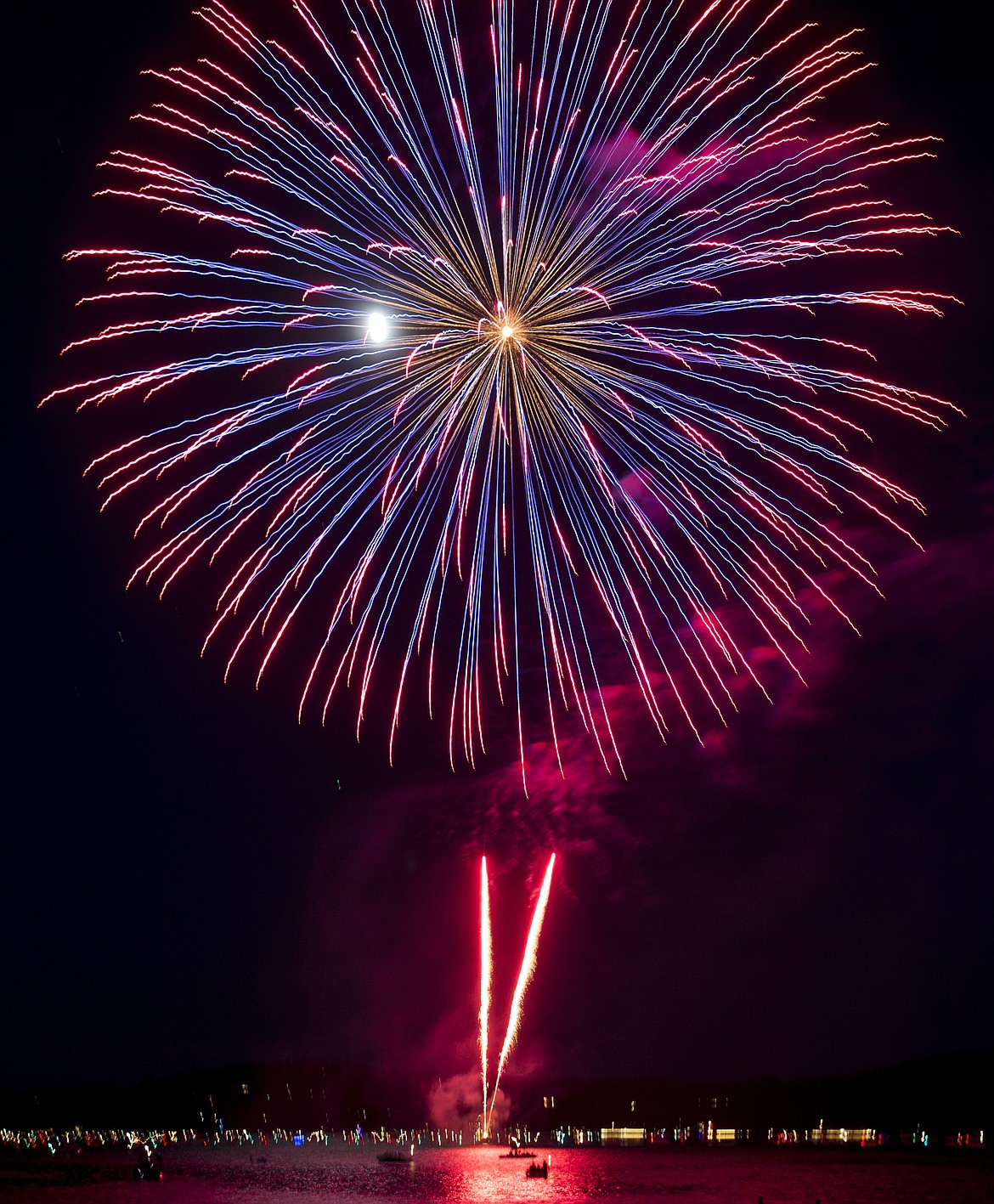 LOREN BENOIT/Press File 
A red and blue firework explodes over Lake Coeur d&#146;Alene with the moon in the background during last year&#146;s Fourth of July celebration.