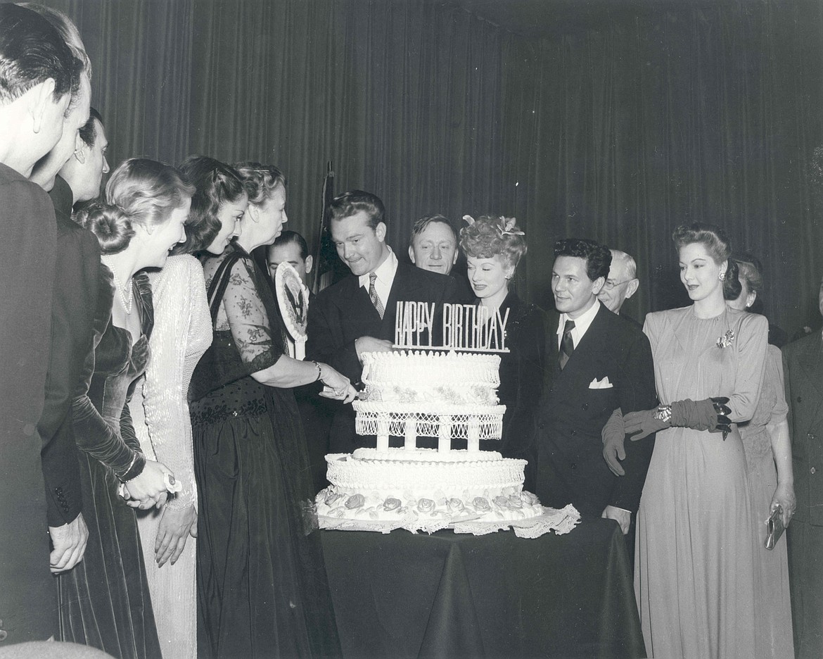 PUBLIC DOMAINEleanor Roosevelt cuts cake at FDR Birthday Ball at Statler Hotel in Washington, D.C., with Red Skelton, U.S. Supreme Court Justice William O. Douglas, Lucille Ball, John Garfield and Maria Montez (1944).