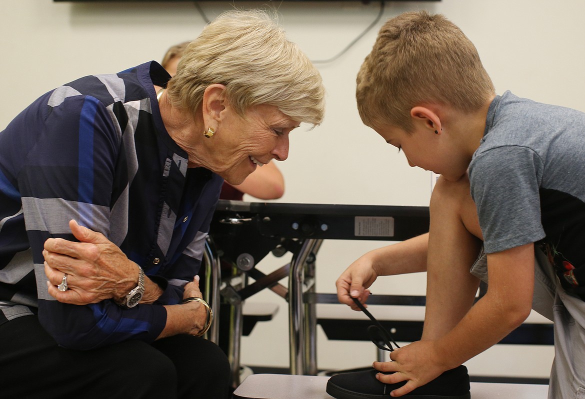 Bentley Kerr, 8, shows off his shoe tying skills for Lola Hagadone Thursday at The Boys and Girls Club of Kootenai County in Coeur d'Alene. (LOREN BENOIT/Press)