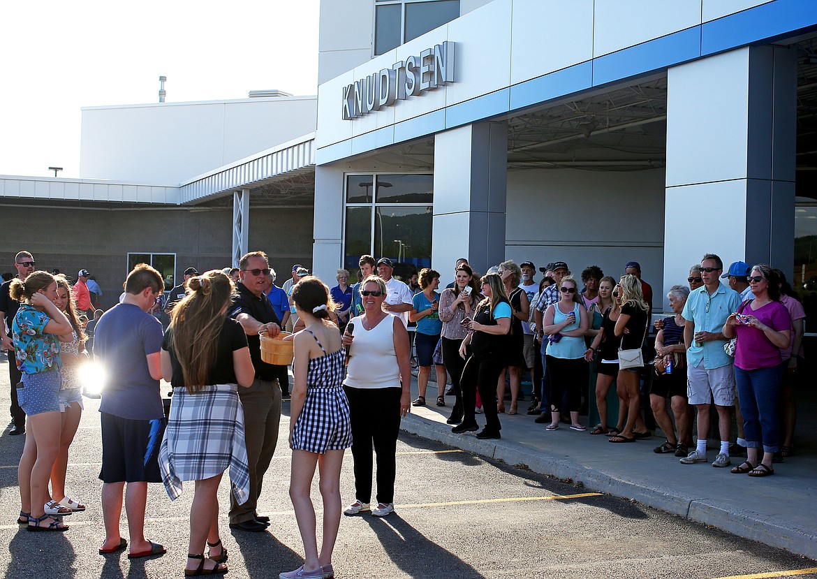 Attendees watch as students from Post Falls, Lake City, Coeur d'Alene, and Timberlake high schools are presented with keys to unlock a 2019 Chevy Cruze Thursday at Knudsten Chevrolet's car giveaway and 80th anniversary celebration. (LOREN BENOIT/Press)