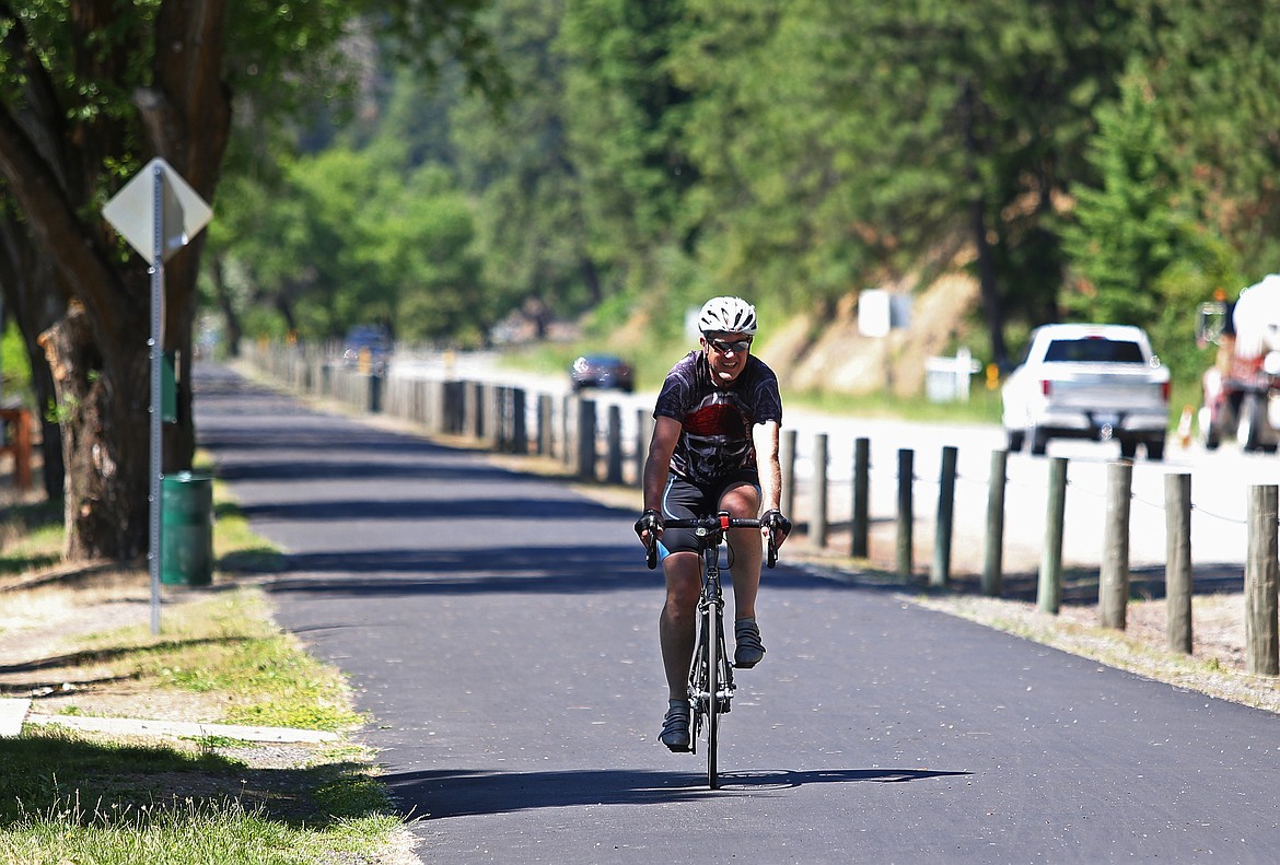 Randy Pollock, of Post Falls, rides his bike along the North Idaho Centennial Trail on Tuesday. (LOREN BENOIT/Press)