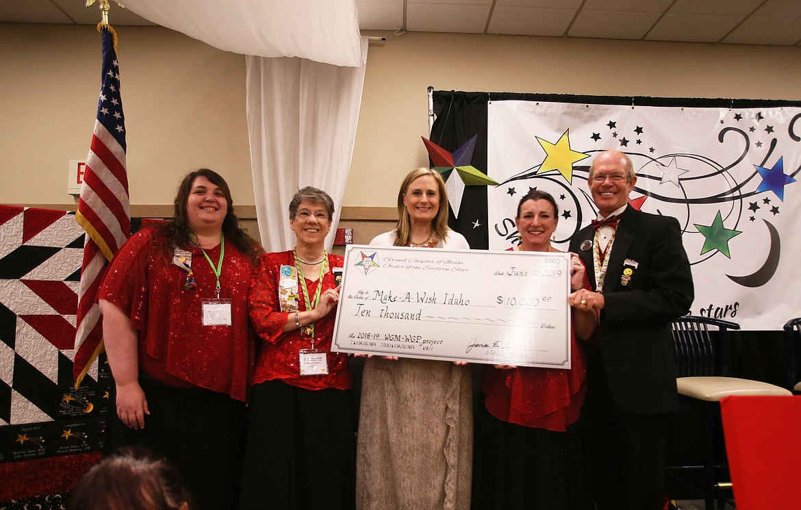 Members of the Idaho Grand Chapter of the Order of the Eastern Star, a charitable Masonic appendant body, spent the last year fundraising for Make-A-Wish Idaho, a nonprofit that helps makes dreams come true for sick and terminally ill kids across the state. During the Eastern Star&#146;s annual state conference in the Best Western Plus Coeur d&#146;Alene Inn on Tuesday, Make-A-Wish Idaho director of development Jessica Budzianowski, center, was presented with a check for $10,000 to continue the mission of bringing joy into the lives of those kids. More funds are being collected from Eastern Star to give to Make-A-Wish Idaho, bringing the donation total to at least $18,000. Visit www.idaho.wish.org to learn about Make-A-Wish Idaho. From left: Eastern Star member Heather Wells, Worthy Grand Matron Joan Heisch, Budzianowski, chair of special projects Diedre Votaw and Worthy Grand Patron Mel Brown.

DEVIN WEEKS/Press