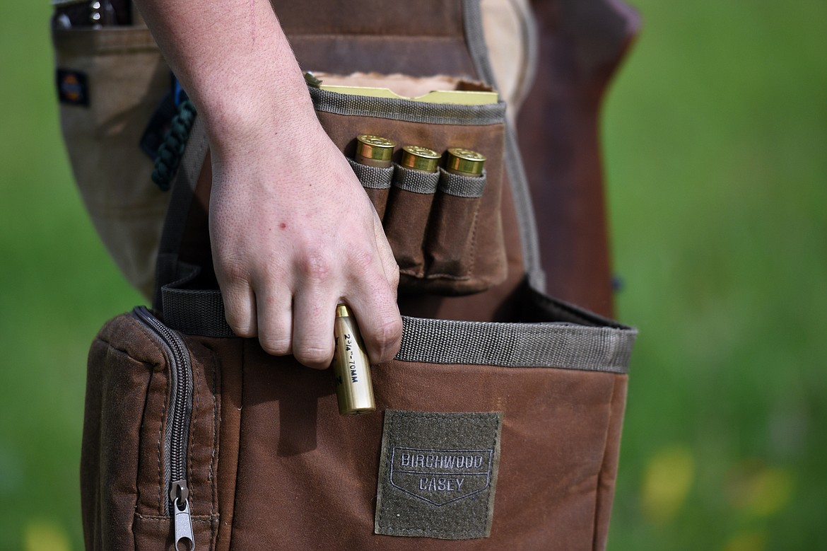 Cody Martin holds a shell while waiting for his turn during a round of trap shooting at Bigfork Gun Club.