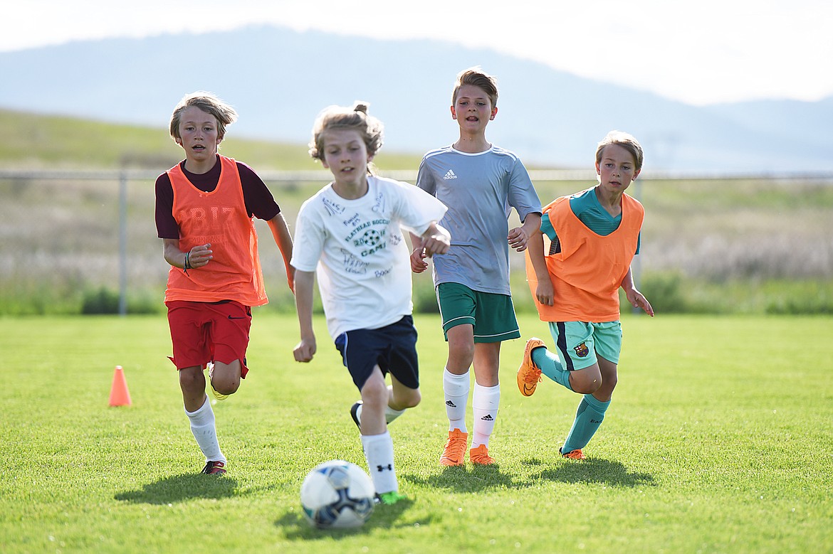 From left, Flathead Force U11 teammates Will Hollensteiner, Isaac Weaks, Liam Breding and Gavin Pyron pursue the ball during an intrasquad scrimmage at practice at Kidsports Complex on Thursday. (Casey Kreider/Daily Inter Lake)