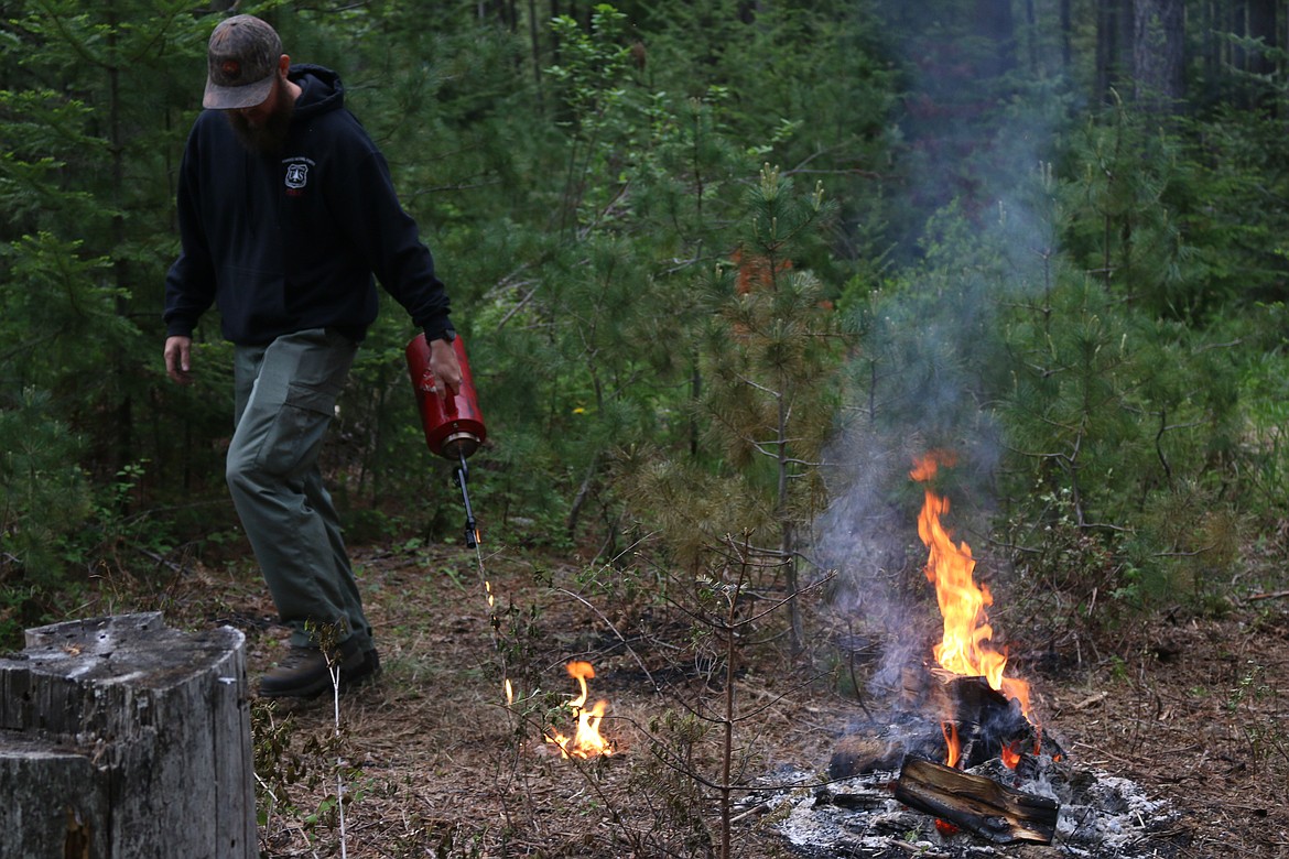 (Photo by MARY MALONE)
Jake Hirst with the U.S. Forest Service sets the ground on fire as he demonstrates a controlled burn to West Bonner County sixth graders during the Priest Community Forest Connection&#146;s annual Forest Expo on May 24 at the Priest River Experimental Forest.