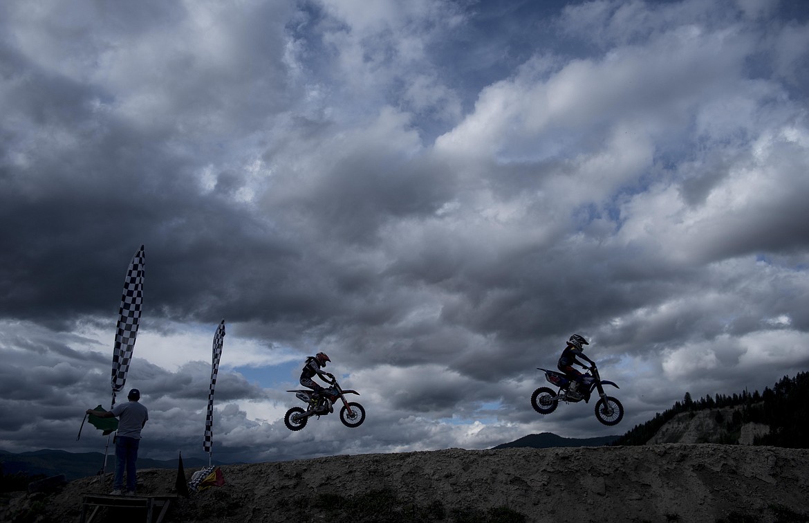 Racers complete a lap to the sound of attendees cheering them on at the Millpond Motocross race, Saturday in Libby. (Luke Hollister/The Western News)