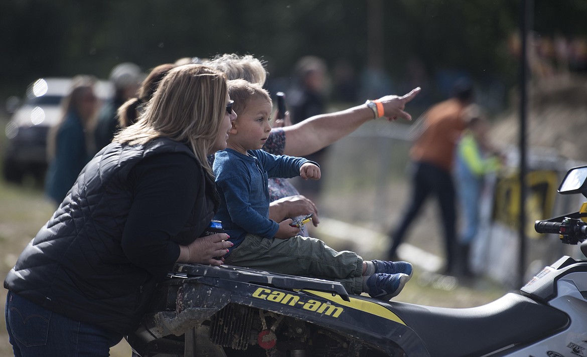 A young motocross fan watches racers fly by during the Millpond Motocross race, Saturday in Libby. (Luke Hollister/The Western News)