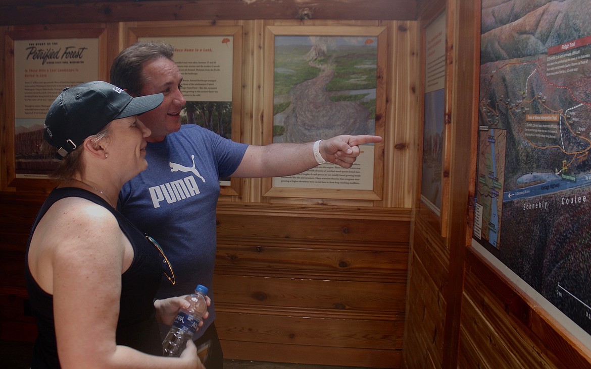 Casey McCarthy/ Columbia Basin Herald  Alixe and Martin Eyles check out the new panels in the trailside museum on Wednesday at Ginkgo Petrified Forest State Park.