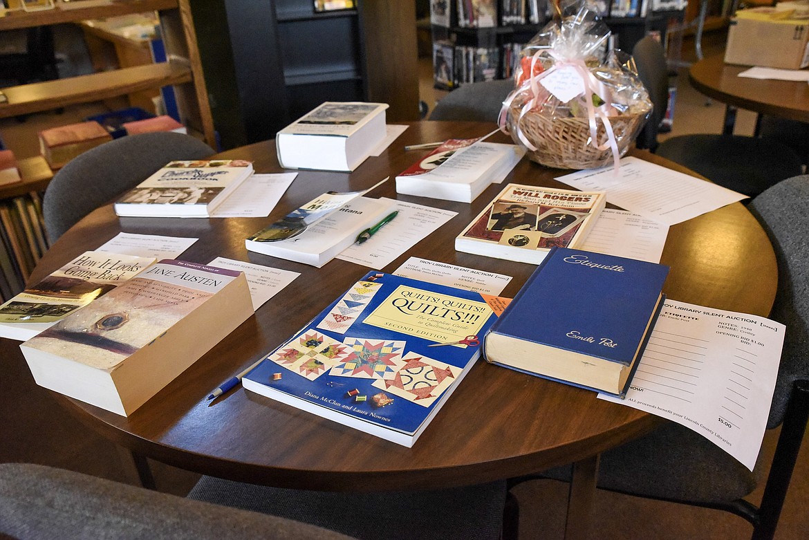 Books and a gift basket  for the silent auction at the Troy Library on Friday, June 7, during the annual Barbecue and Book Sale. (Ben Kibbey/The Western News)