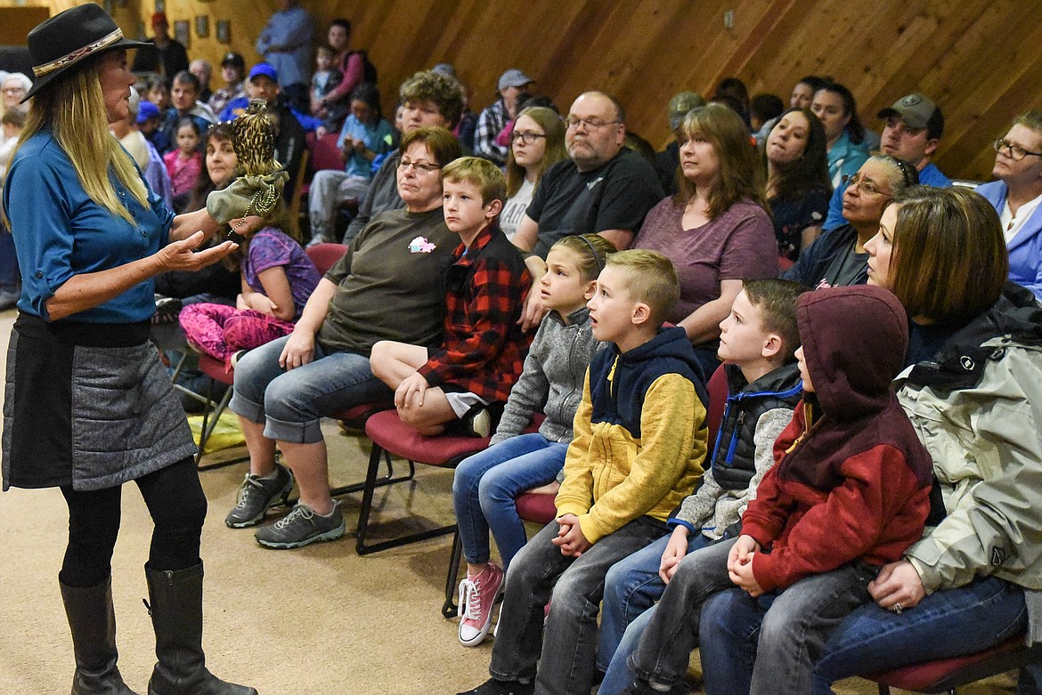 Audience members look at Madelin the Merlin, a falcon, at Birds of Prey Day May 25. (Ben Kibbey/The Western News)