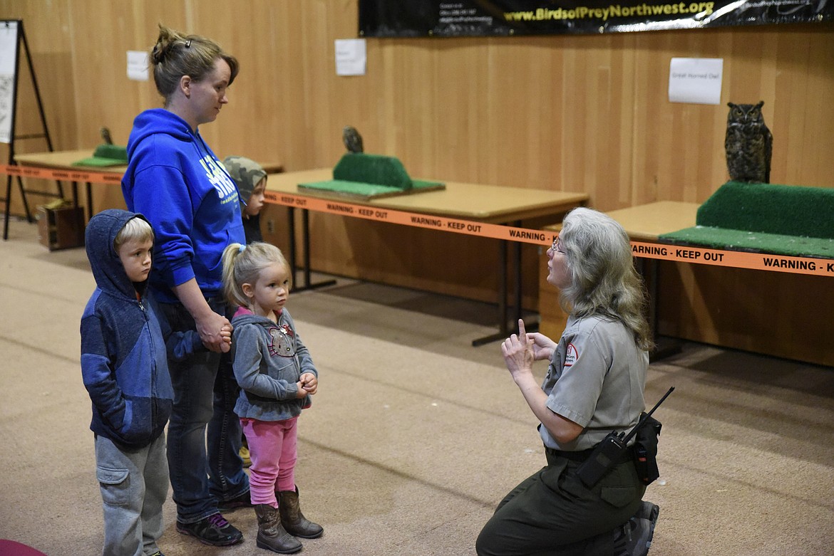 Susan James, with the Libby Dam, talks with the Melody Newmaster and her children (left to right) James, Faith and Joshua, at Birds of Prey Day May 25.. (Ben Kibbey/The Western News)