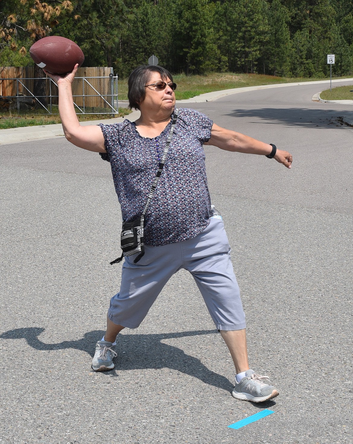 CARRIE IRVINE gives it the old college try, aiming a football for a hoop in the Two Eagle River School Elder Olympics.