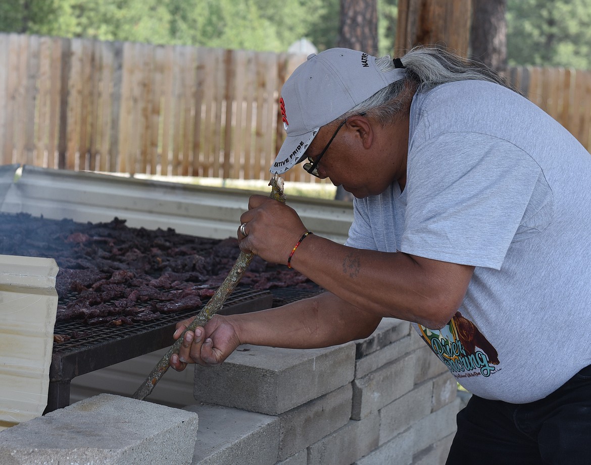 NKWUSM SALISH Language School Cultural Specialist Allen Pierre tends the fire, in an all-day process of smoking elk meat for the next day&#146;s powwow. &#147;We rely on the smoke, not the flame, to give it that flavor,&#148; he says.