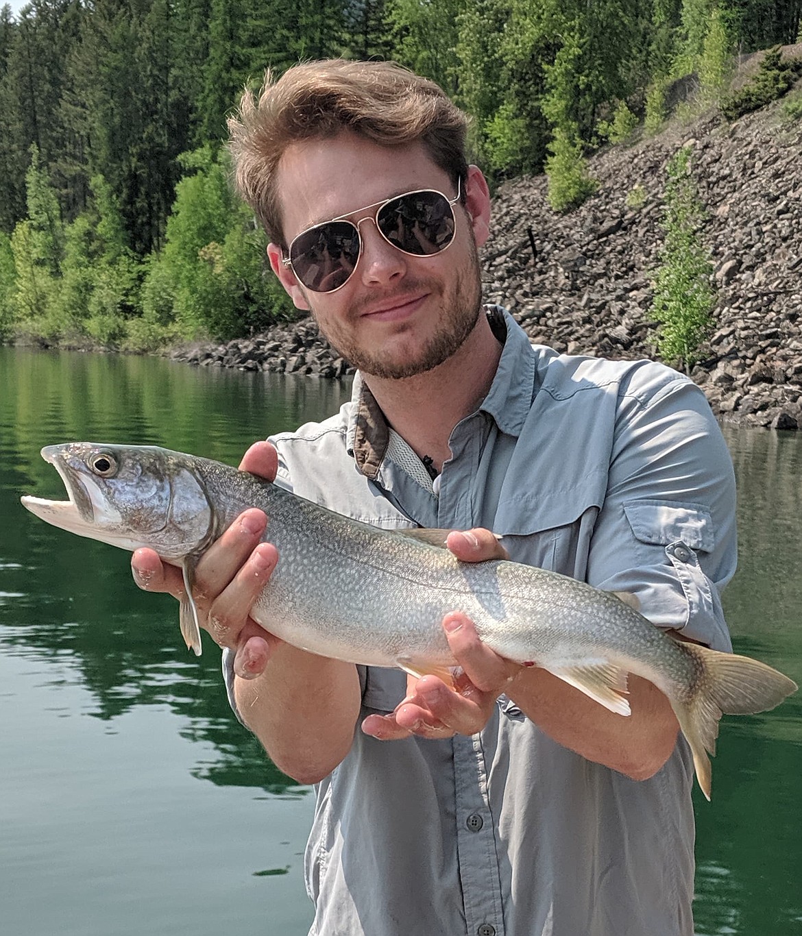 JOHN DOWD, the new reporter/photographer at the Clark Fork Valley Press, loves to recreate in his spare time. He shows a nice lake trout he reeled in before locating in Sanders County. (Courtesy photo)