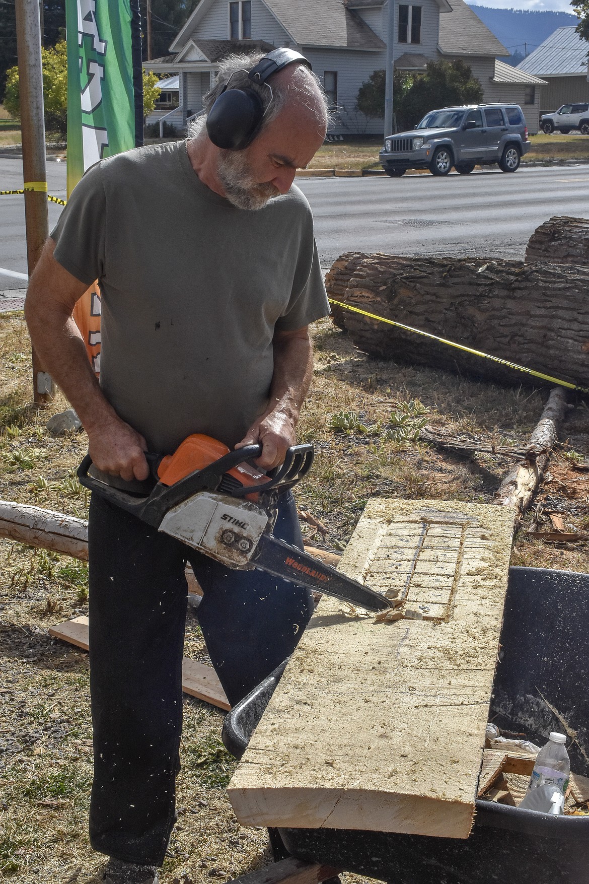 Gary Jewell, from Trego, works on one of his customary chainsaw-carved sign during the quick carve period on Sunday, Sept. 24, 2018, at Ron Adamson&#146;s The Libby Chainsaw Event. (Ben Kibbey/The Western News)