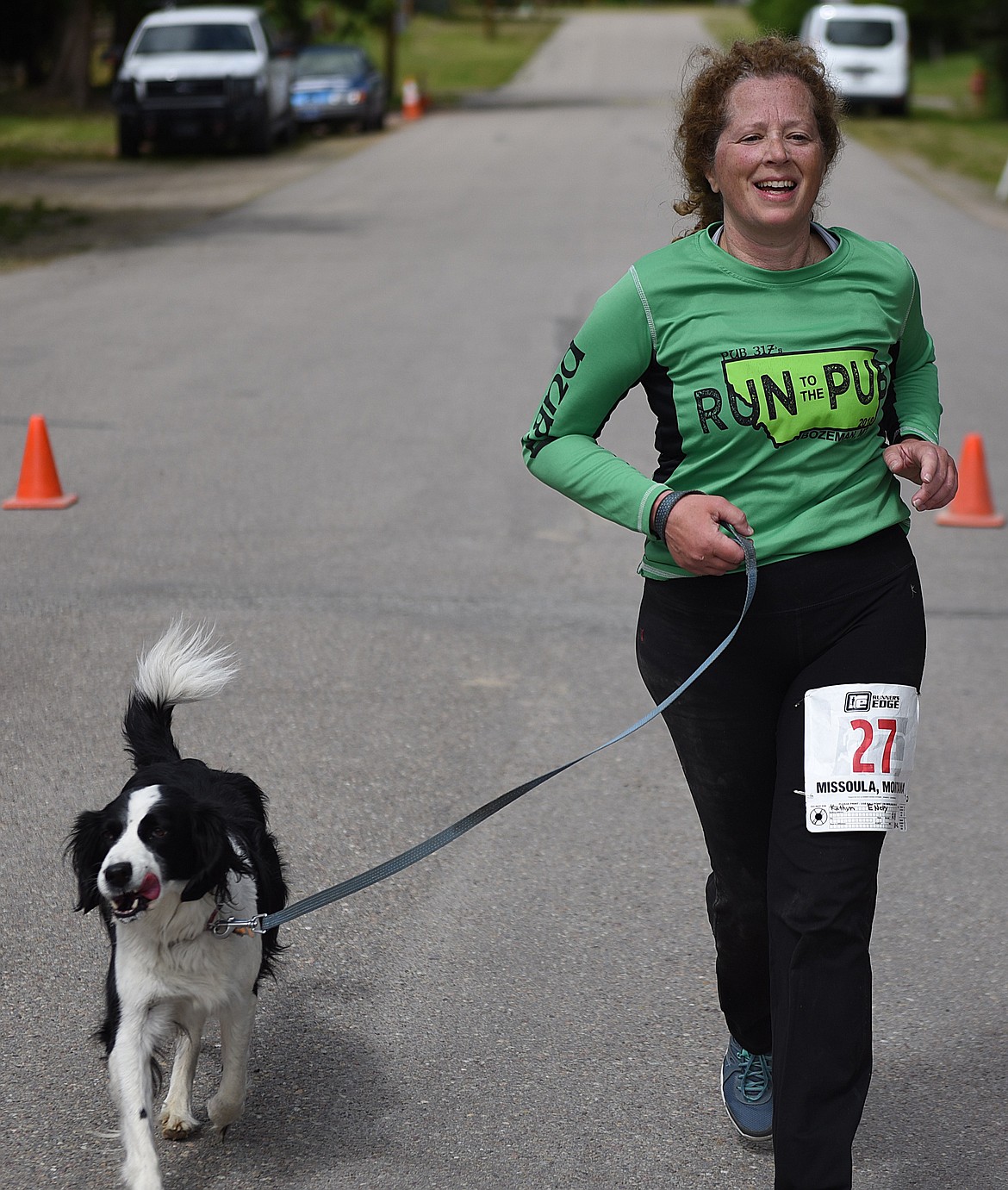 KATHRYN ENERY completes the 10K portion of the Skunk Alley Fun Run last Saturday, June 8 with her canine companion Lily, a beautiful spaniel who was up to the task of a &#147;long walk.&#148; Enery earned third place in the 50-59 female division of the 10K. Her time was 1:09:21. (Joe Sova photos/Clark Fork Valley Press)