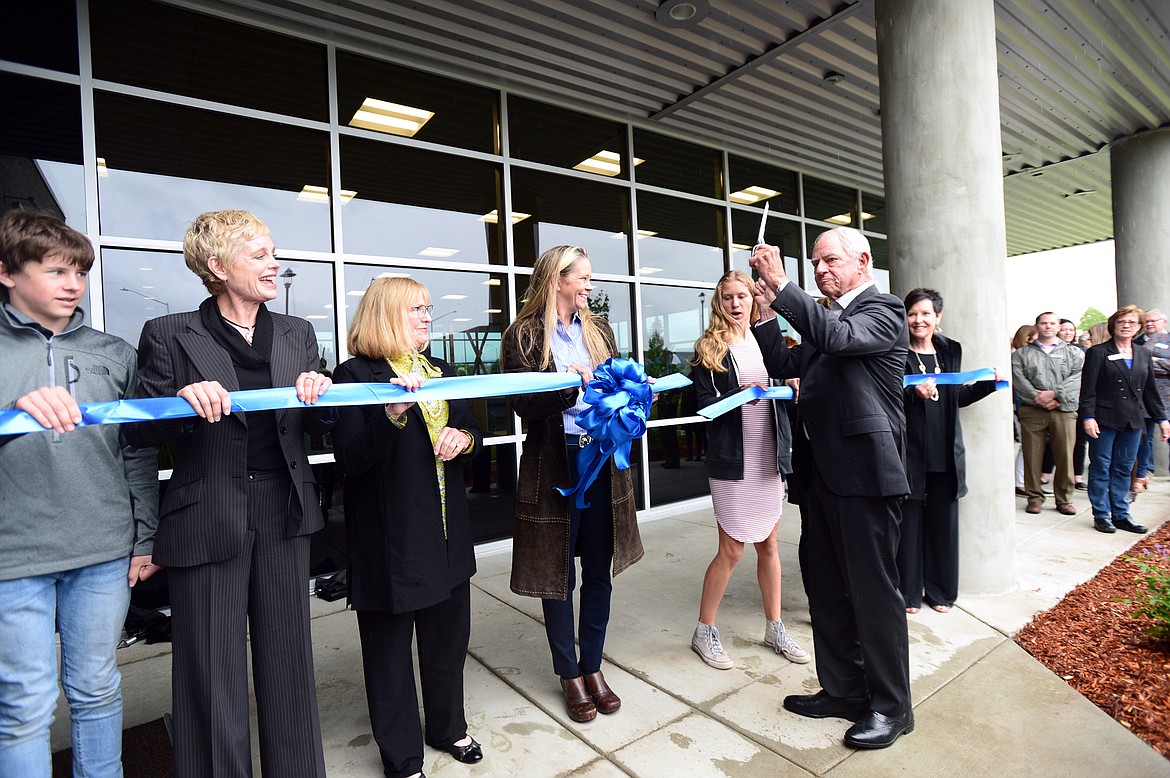 Jerome Broussard cuts the ribbon outside the new Broussard Family Library and Learning Commons at Flathead Valley Community College on Thursday. (Casey Kreider/Daily Inter Lake)