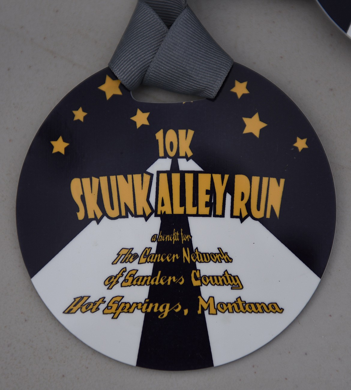 ENTRANTS  WHO placed in the top three of their age groups in the 10K portion of the Skunk Alley Fun Run received a nice medal, pictured at right. The top three in each division of the 3K race were given smaller  medals.