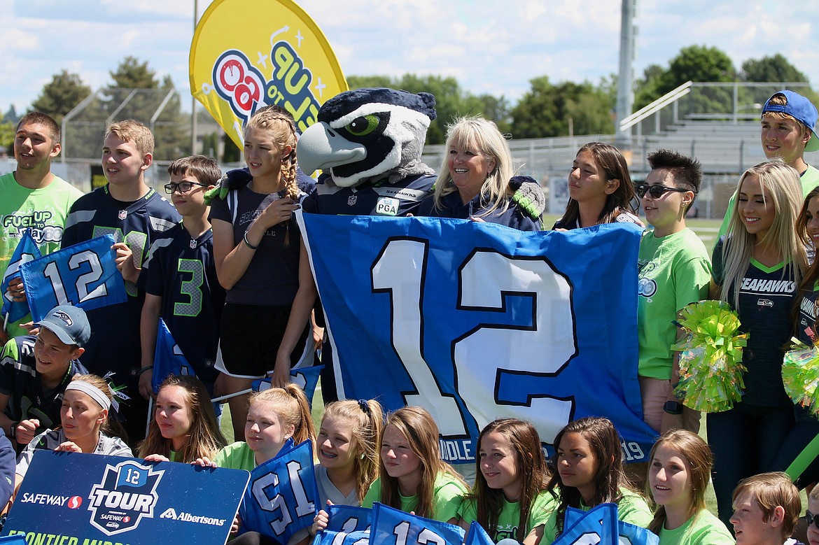 Casey McCarthy/ Columbia Basin Herald Frontier Middle students, faculty, and members of the Seattle Seahawks organization gather in honor of the school's social media contest victory that resulted in getting to meet a former NFL player on Friday.