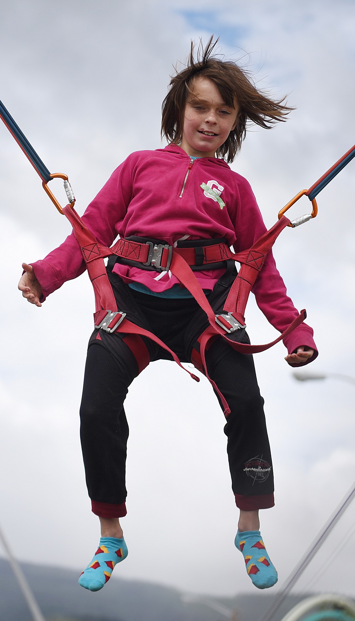 ELEANORE MASSEY, 8, has great fun on the bungee trampoline in downtown Hot Springs during Homesteader Days activities last Saturday morning. (Joe Sova/Clark Fork Valley Press)