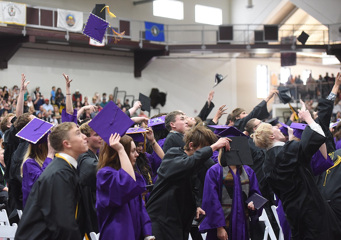 MEMBERS OF the Polson High School Class of 2019 celebrate receipt of their diploma by tossing their caps in the air at the Joe McDonald Health &amp; Fitness Center at SKC.