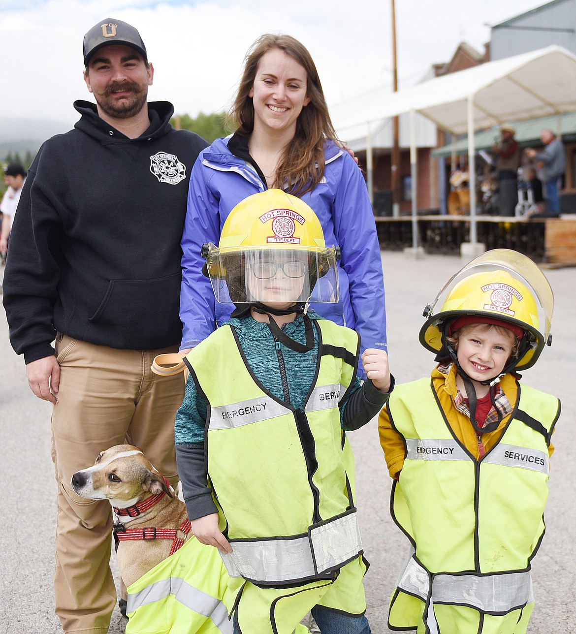 MEMBERS OF the Wilson and Fisher family dressed as firemen, and their pooch as well, for the parade. Pictured are Braden Fisher, left, and Owen Wilson, right. Also in on the photo are Owen&#146;s mom Erin Wilson and Braden&#146;s dad Lyle Fisher.