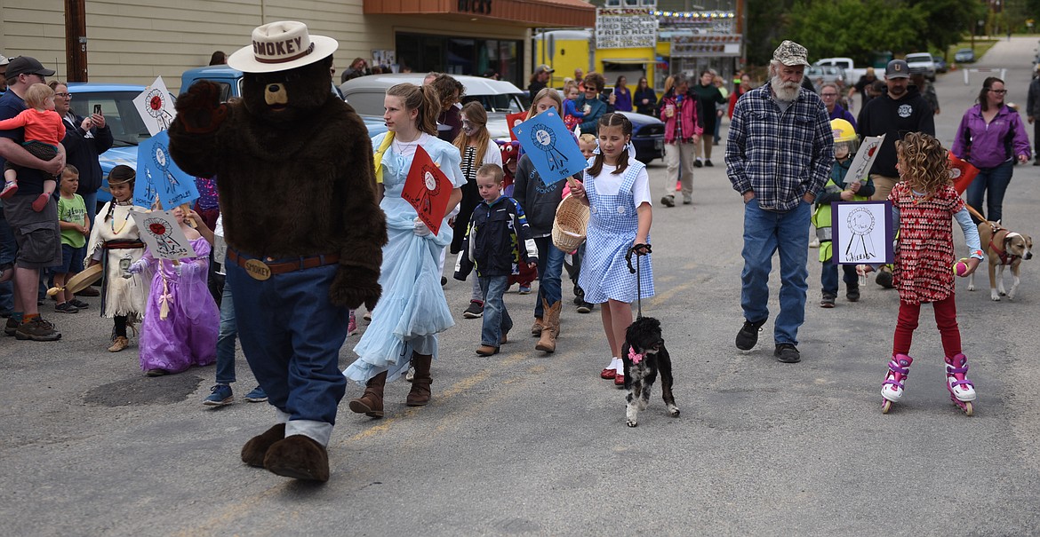 SMOKEY BEAR leads the entourage down Main Street during the Homesteader Days Kiddie Parade on Saturday afternoon, June 8 in Hot Springs. Prizes were presented to the top three costumes in five different categories. They included Homesteaders, Fairy Tale, Pets, Wheels and Miscellaneous. (Joe Sova photos/Clark Fork Valley Press)