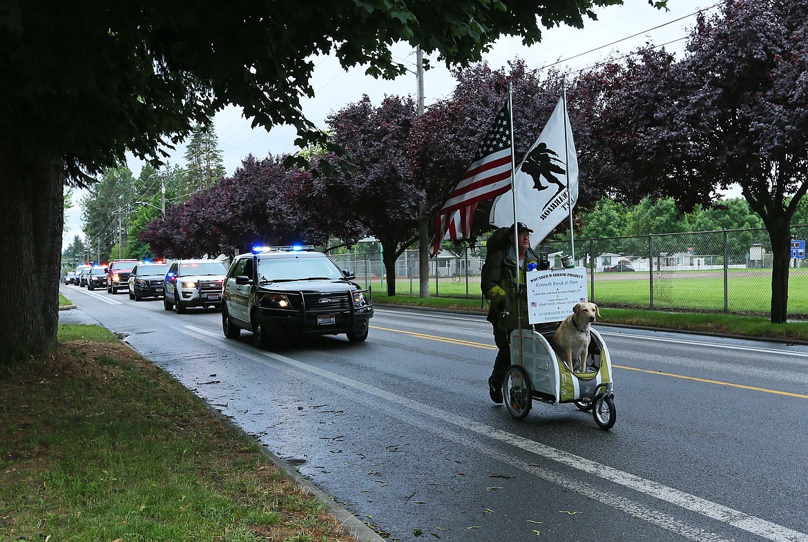 Kenneth Brock and his dog, Pam, are followed to Cherry Hill Park in Coeur d&#146;Alene by personnel from the Kootenai County Sheriff&#146;s Office, Post Falls Police Department, Coeur d&#146;Alene Police Department, Idaho State Police and U.S. Forest Service.