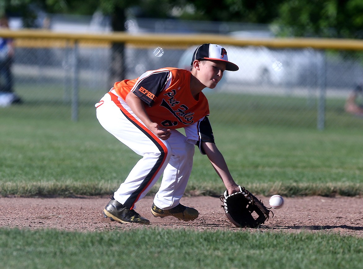 Post Falls third baseman Gavin Winker fields a ground ball in a Little League District 1 Majors tournament game against Hayden on Friday at the Canfield Sports Complex in Coeur d&#146;Alene. Harrison Evans and Kolby Coey each drove in three runs as Hayden defeated Post Falls 15-0. (LOREN BENOIT/Press)