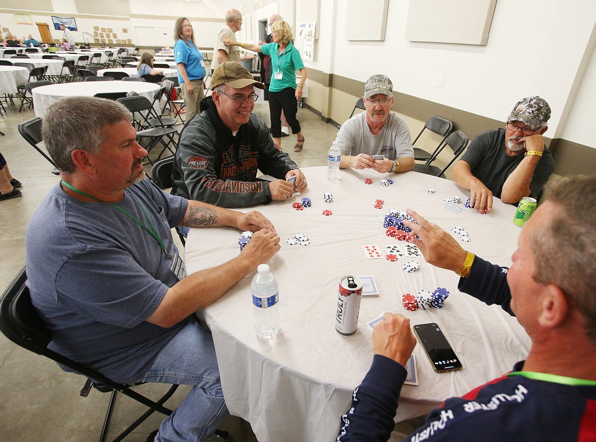 From left, John Parker, Jerry Spalding, Larry Williamson, James Stuart, and Troy Anderson play a game of poker Tuesday at the Kootenai County Fairgrounds. About 400 people hearing impaired campers will be spending the week participating in arts and crafts, playing night games for prizes at the Kootenai County Fairgrounds, riding the gondolas at Silver Mountain and other activities.

LOREN BENOIT/Press