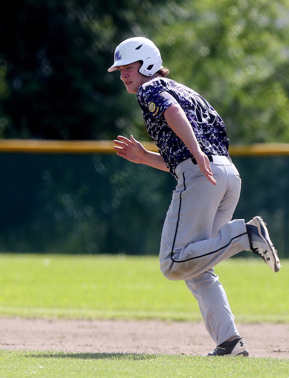 Northern Lakes Mountaineer baserunner Cole Strietzel runs to second base on a pass ball in a game against Lewis-Clark Tuesday at Lakeland High School. (LOREN BENOIT/Press)