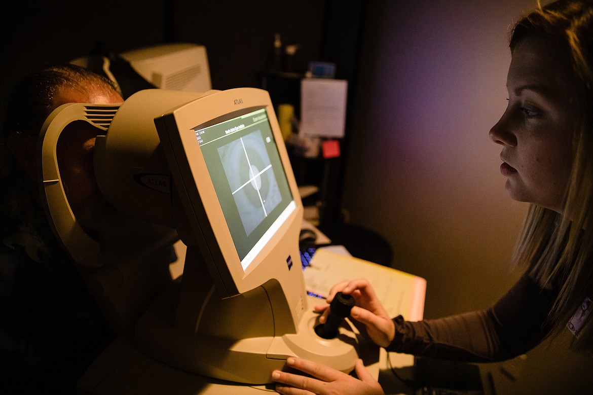 Above: Megan Berger, a technician at North Idaho Eye Institute in Coeur d&#146;Alene, performs a cataract diagnostic test on Dan Tarver during his appointment.

Left: Suzi Berger tries on a pair of frames in the optical shop at the North Idaho Eye Institute in Coeur d&#146;Alene.