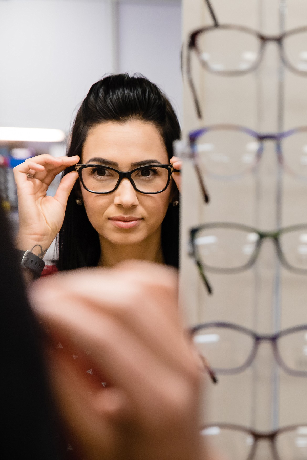 Suzi Berger tries on a pair of frames in the optial shop at the North Idaho Eye Institute in Coeur d&#146;Alene.