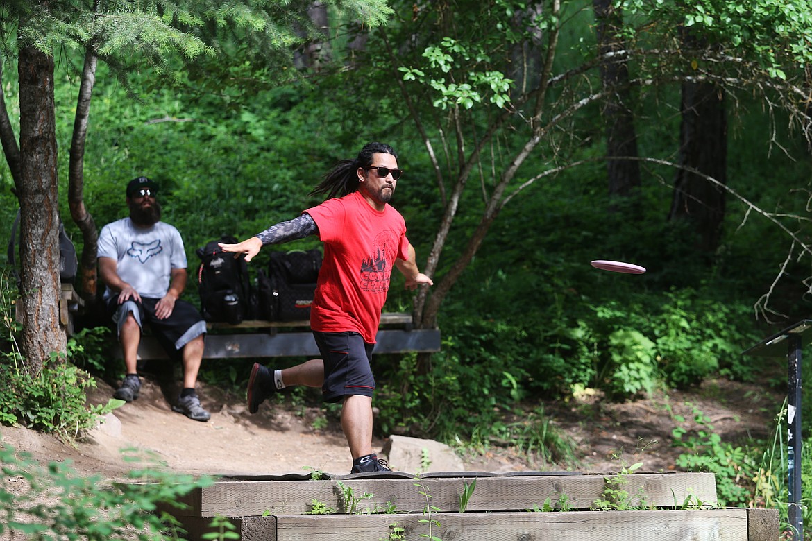 Tim Gisel hurls a disc off the hole three tee during a disc golf tournament held June 12, 2019 at Cherry Hill. (LOREN BENOIT/Press)