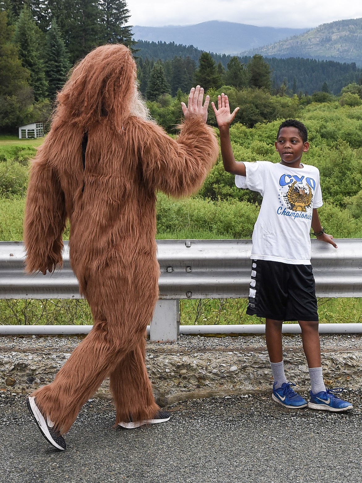 Sasquatch gives a high five to third-place finisher Nassun Schmidt during the 2019 Sasquatch Run at the annual Yaak Sasquatch Festival. (Ben Kibbey/The Western News)