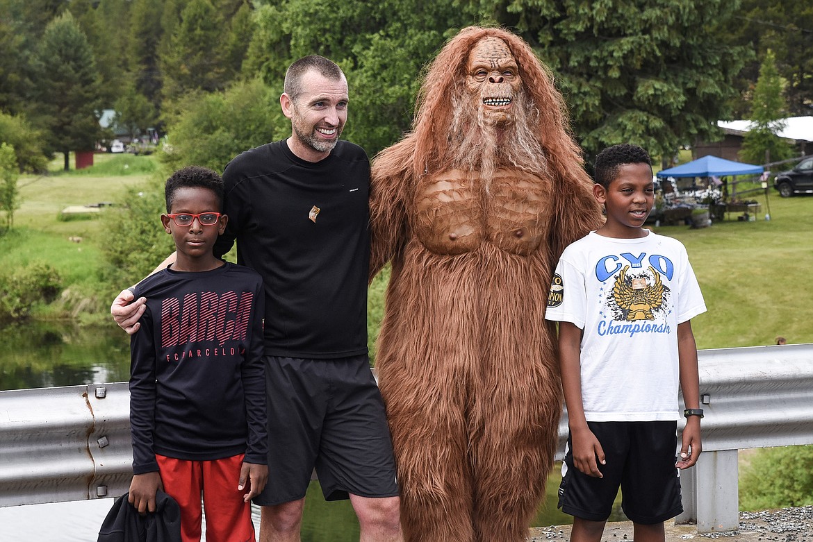 Sasquatch mugs for a photo with runners after the 2019 Sasquatch Run at the annual Yaak Sasquatch Festival, Saturday. Left to right, Abdur Schmidt, Brandon Schmidt, sasquatch and Nursun Schmidt. (Ben Kibbey/The Western News)