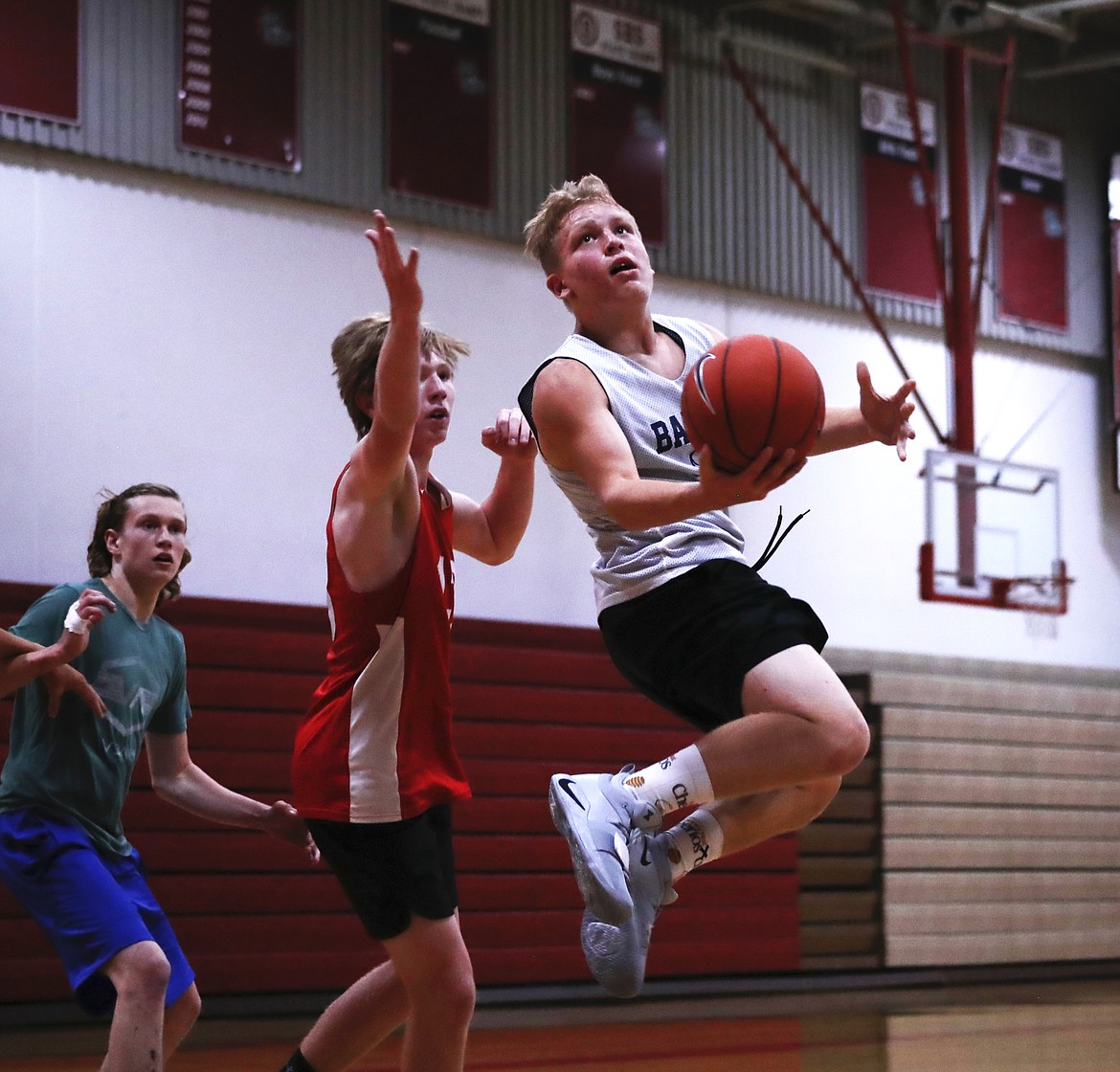 (Photo by KYLE CAJERO)
Bonners Ferry's Travis Peterson switches hands mid-air during a scrimmage against Sandpoint on June 18.