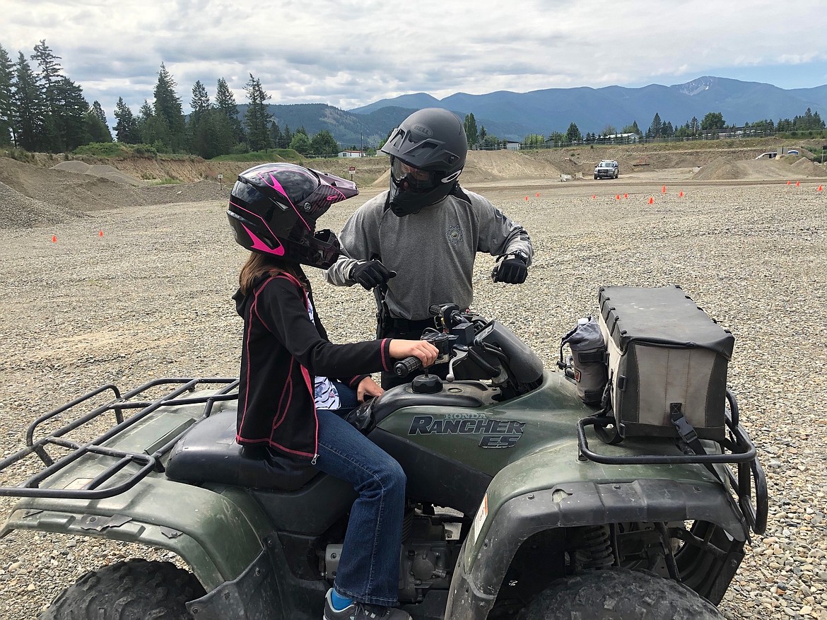 Courtesy photo
Boundary County Undersheriff Rich Stephens giving pointers to one of the young riders on her ATV.