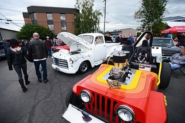 Visitors stroll through The Big Shindig outside The DeSoto Grill in Kalispell on Saturday. The Big Shindig features a wide range of classic, custom and unfinished cars as well as live music, barbeque, beer and a pin-up polar plunge. (Casey Kreider/Daily Inter Lake)