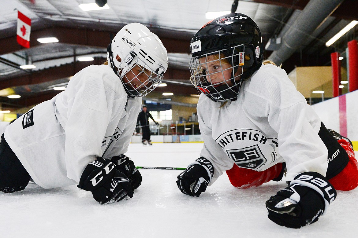 Young campers try to knock each other off-balance while on their kneepads and gloves during a drill the L.A. Kings Summer Camp-Whitefish at Stumptown Ice Den in Whitefish on Thursday. (Casey Kreider/Daily Inter Lake)