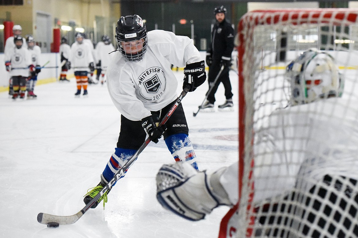Austin Hlavnicka, 11, of Great Falls, readies his shot during a breakaway drill at L.A. Kings Summer Camp-Whitefish at Stumptown Ice Den in Whitefish on Thursday. (Casey Kreider/Daily Inter Lake)