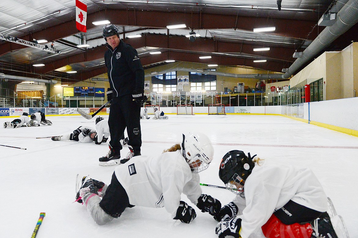 Derek Armstrong, a former Los Angeles King and current director of hockey programming and curriculum with the team, skates past campers as they work on drills at the L.A. Kings Summer Camp-Whitefish at Stumptown Ice Den in Whitefish on Thursday. (Casey Kreider/Daily Inter Lake)