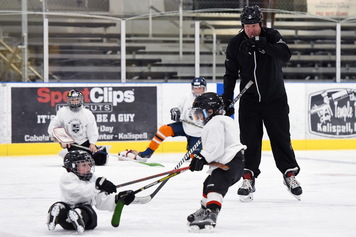 Derek Armstrong, a former Los Angeles King and current director of hockey programming and curriculum with the team, blows a whistle as campers finish up a drill at the L.A. Kings Summer Camp-Whitefish at Stumptown Ice Den in Whitefish on Thursday. (Casey Kreider/Daily Inter Lake)