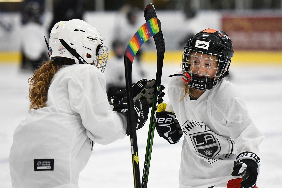 Young campers switch sticks during a drill at the L.A. Kings Summer Camp-Whitefish at Stumptown Ice Den in Whitefish on Thursday. During the drill, campers were instructed to stand their sticks up and, once a whistle was blown, grab their fellow campers' stick before it could fall to the ice. (Casey Kreider/Daily Inter Lake)