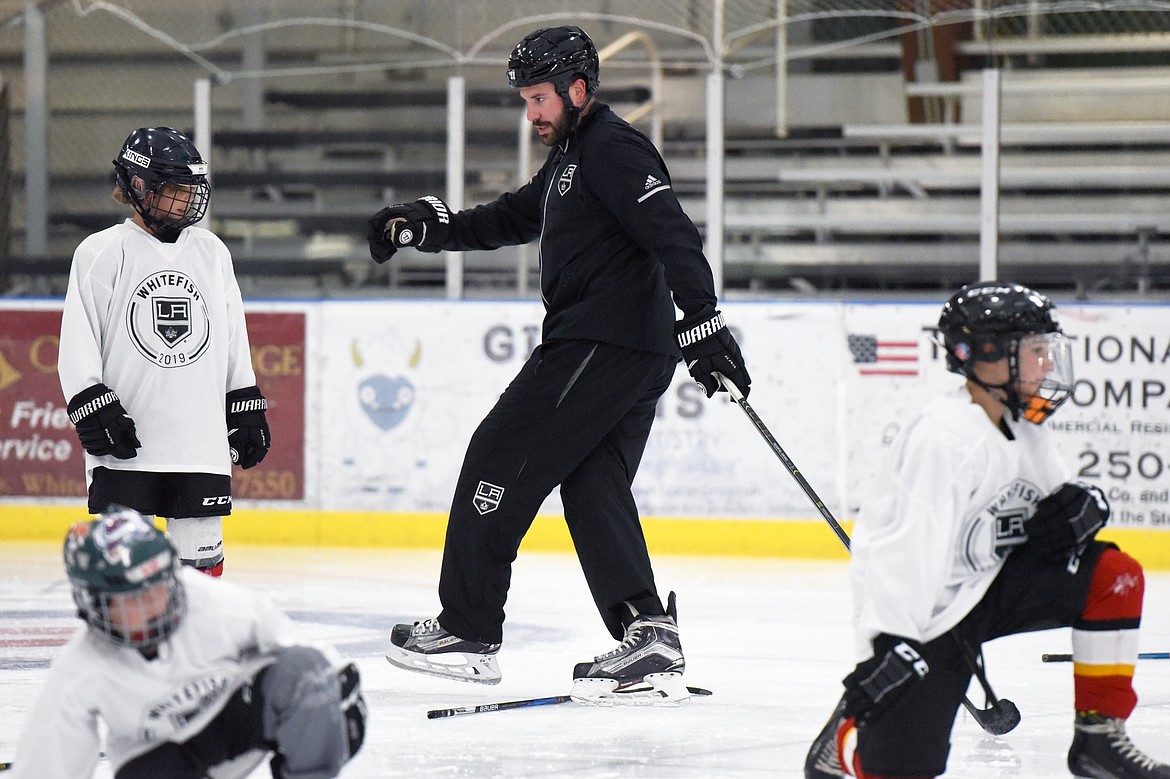 Courtney Ports, manager of hockey development with the Los Angeles Kings, demonstrates a footwork drill with campers at the L.A. Kings Summer Camp-Whitefish at Stumptown Ice Den in Whitefish on Thursday. (Casey Kreider/Daily Inter Lake)