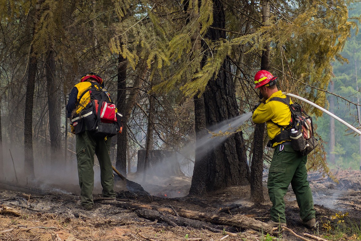 Firefighters work as a team to put out a fire near Moon Shadow Road on June 13.

Photo by MIKE ELAM / NORTH BENCH FIRE