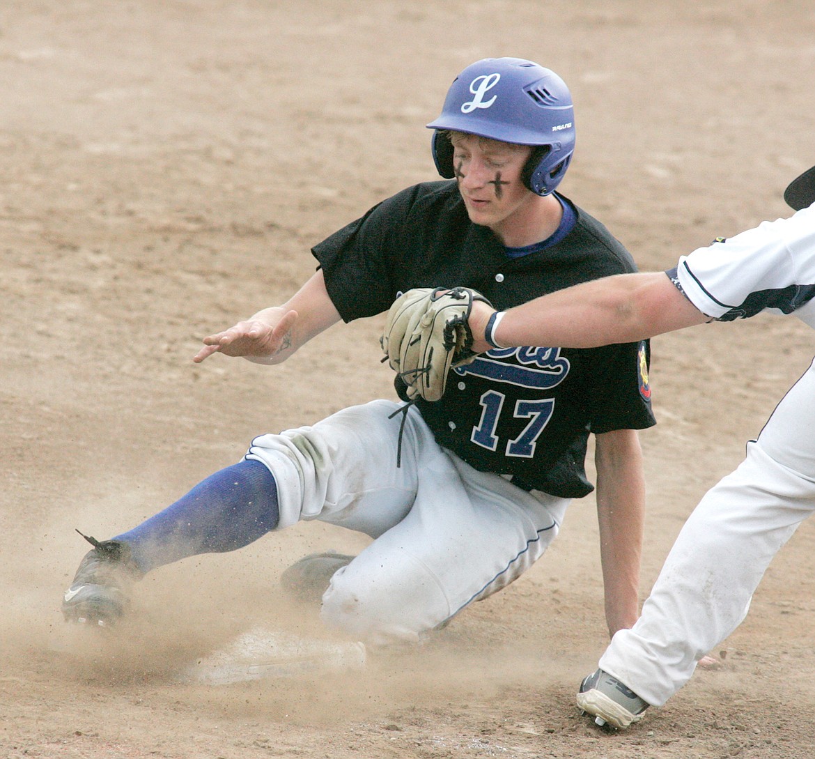 Ethan Borden steals second then advances safely to third on a fielding error narrowly escaping the tag of third baseman Andrew Scully. Bitterroot Bucs over Loggers 13-2 in Sunday's Big Bucks championship game. (Paul Sievers/The Western News)