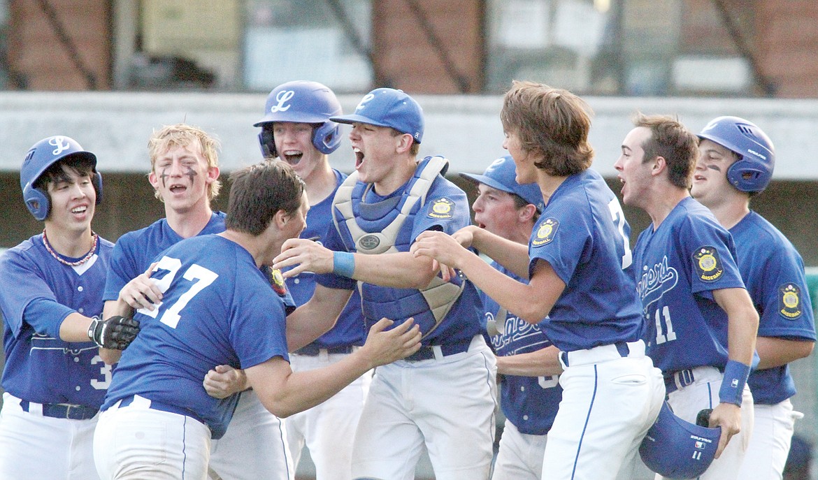 The Loggers celebrate Saturday after defeating the Tri-County Cardinals 4-3, bottom of seventh with two out, after Shayne Walker smacked a double to center field on the 0-1 pitch, scoring Jeff Offenbecher and Tripp Zhang. (Paul Sievers/The Western News)