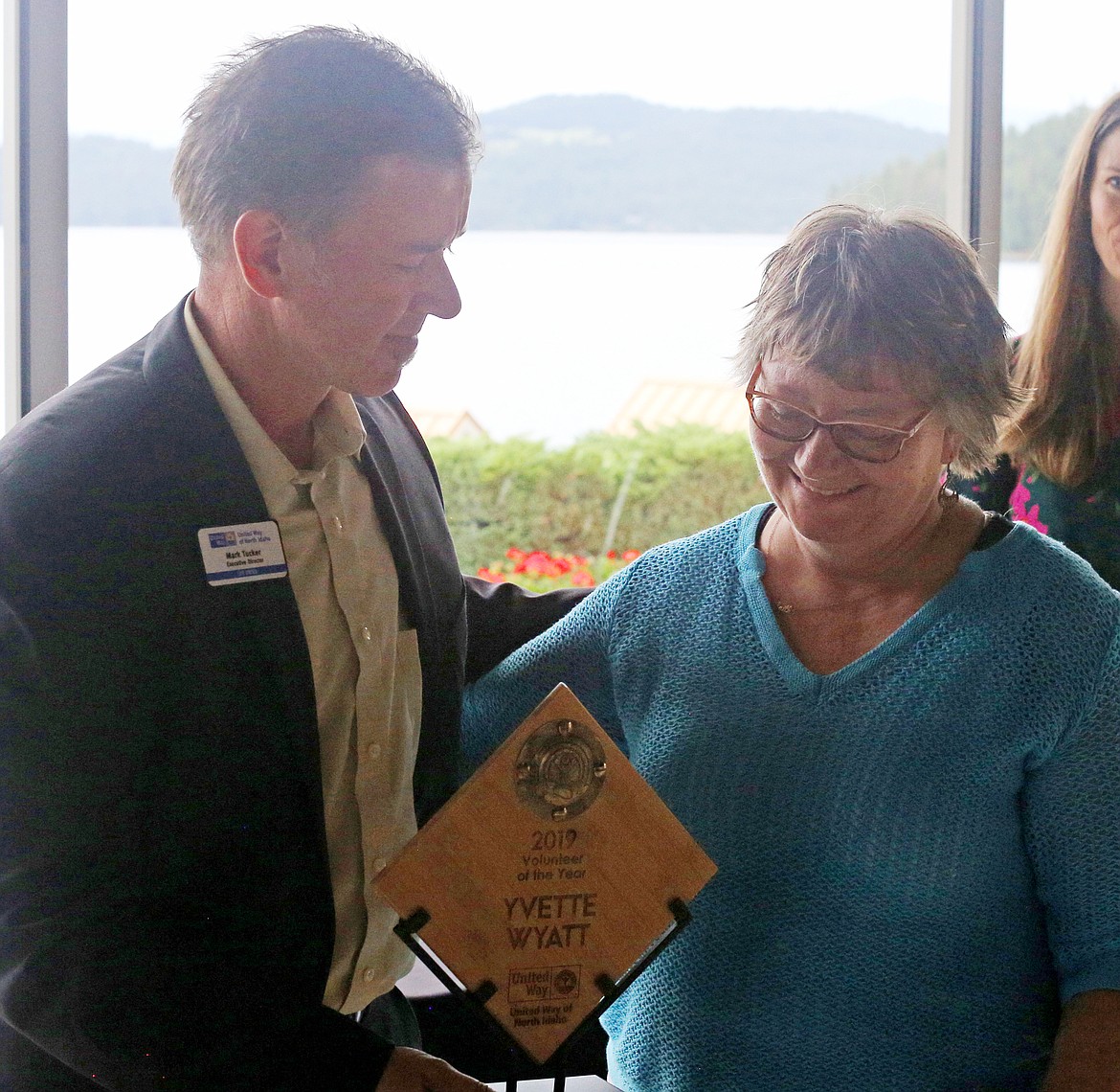 United Way Executive Director Mark Tucker presents the Volunteer of the Year Award to Yvette Wyatt, with CDAide, during United Way&#146;s awards luncheon Wednesday at The Hagadone Event Center. (LOREN BENOIT/Press)